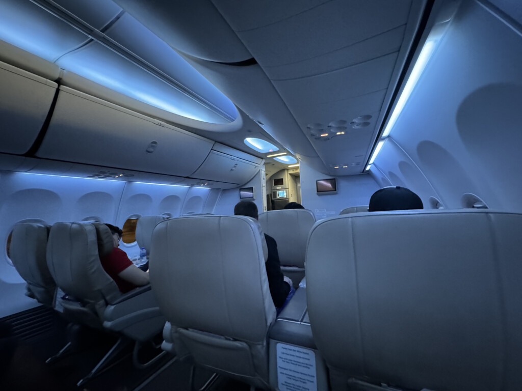 a group of people sitting in an airplane