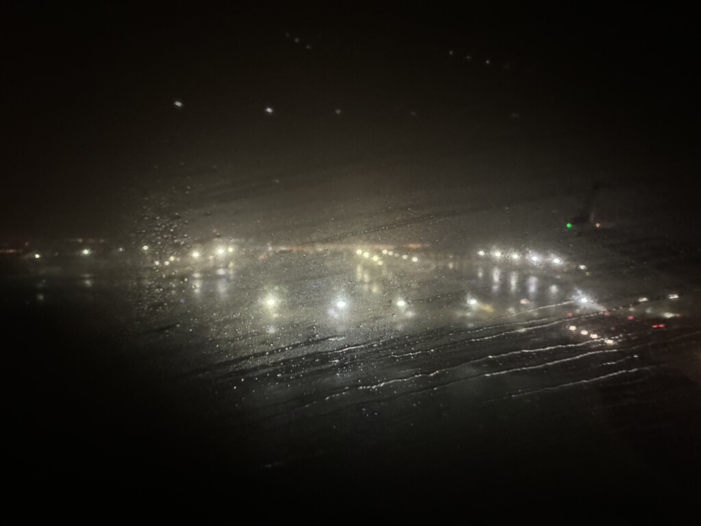 a city lights on a wet surface