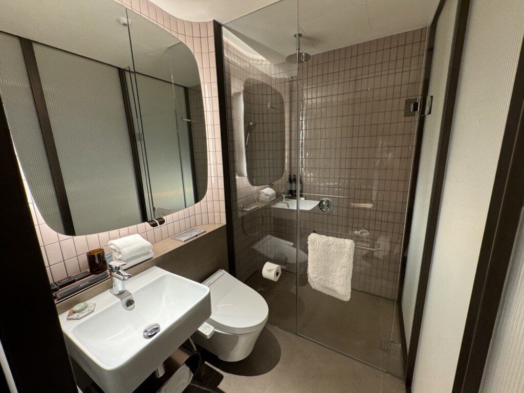 a bathroom with a glass shower and sink