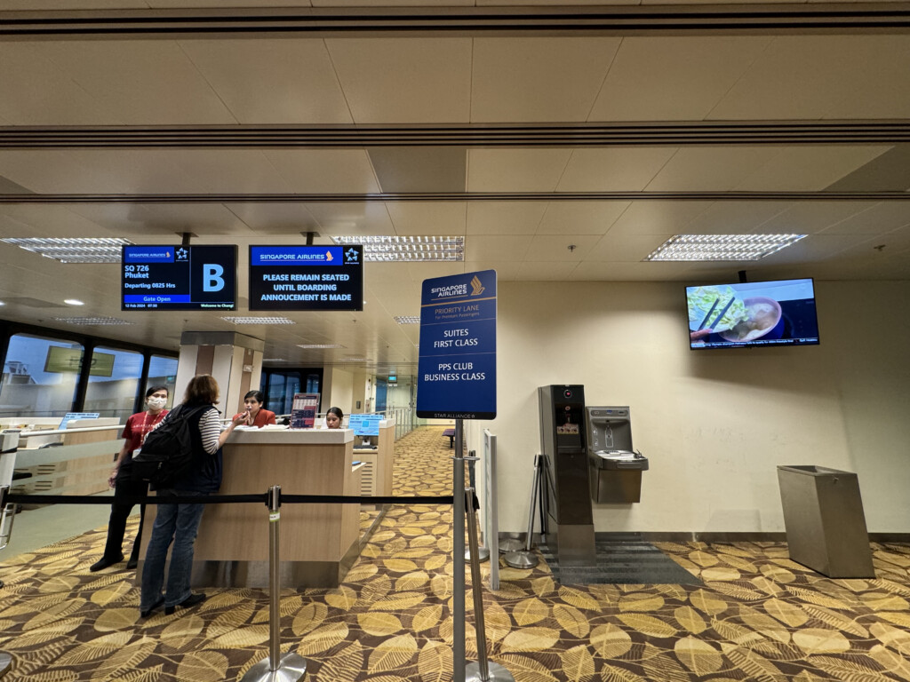 people standing in a line at an airport