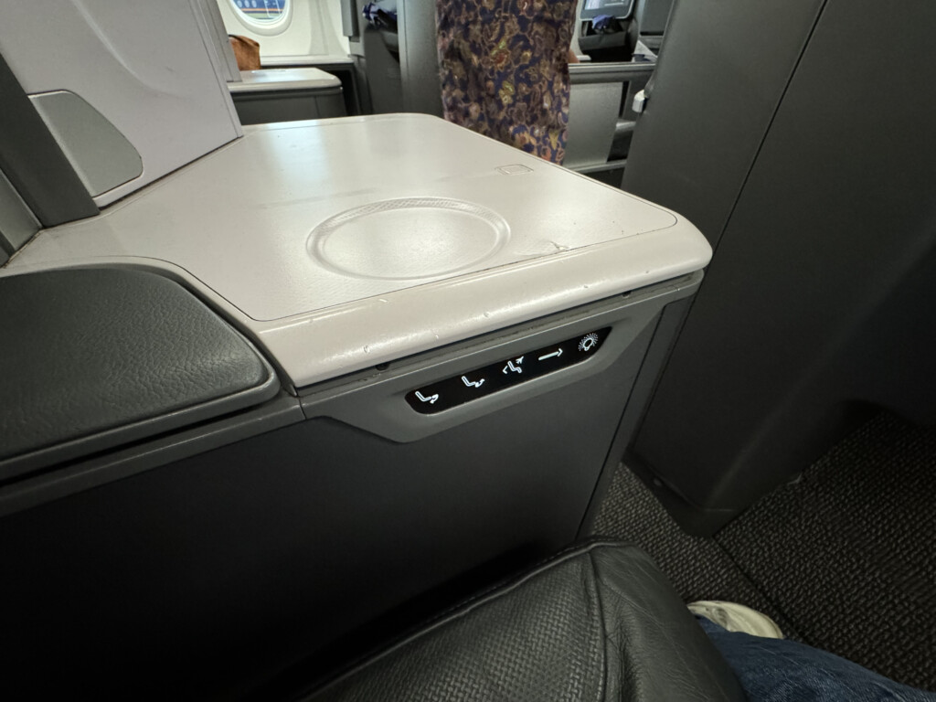 a seat with buttons and buttons on the side of the seat