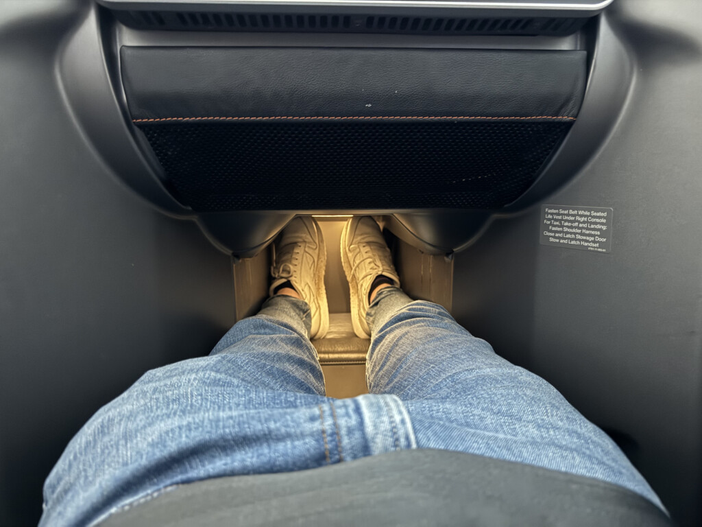 a person's legs in jeans and sneakers