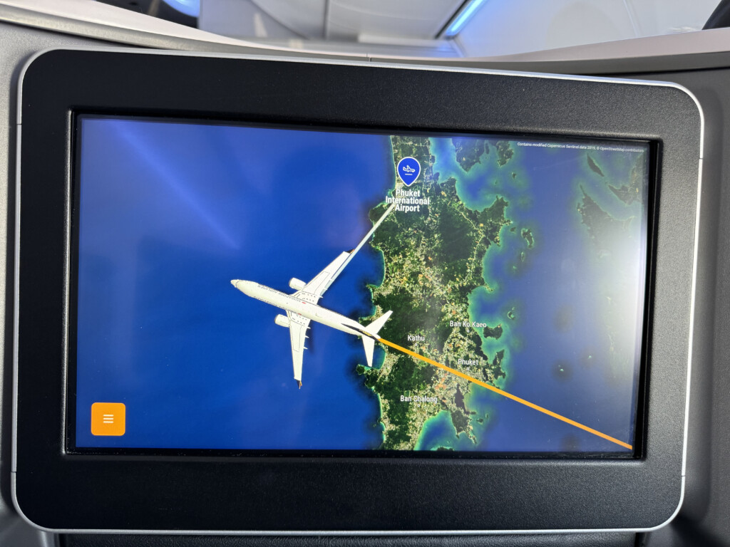 a screen with a plane flying in the sky