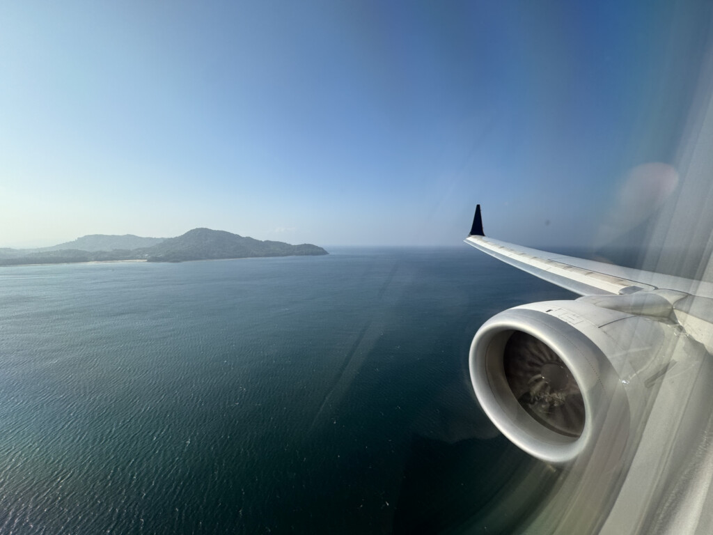 an airplane wing and a body of water