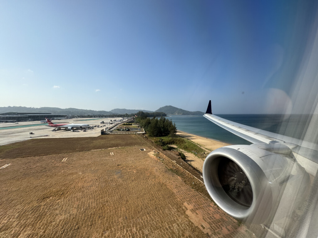 an airplane wing and engine on a beach