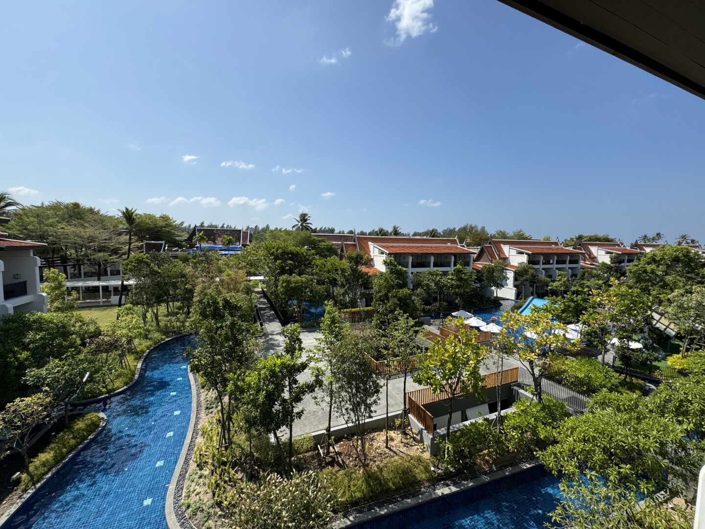 a pool with trees and buildings in the background