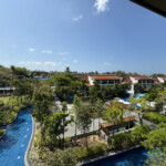 a pool with trees and buildings in the background