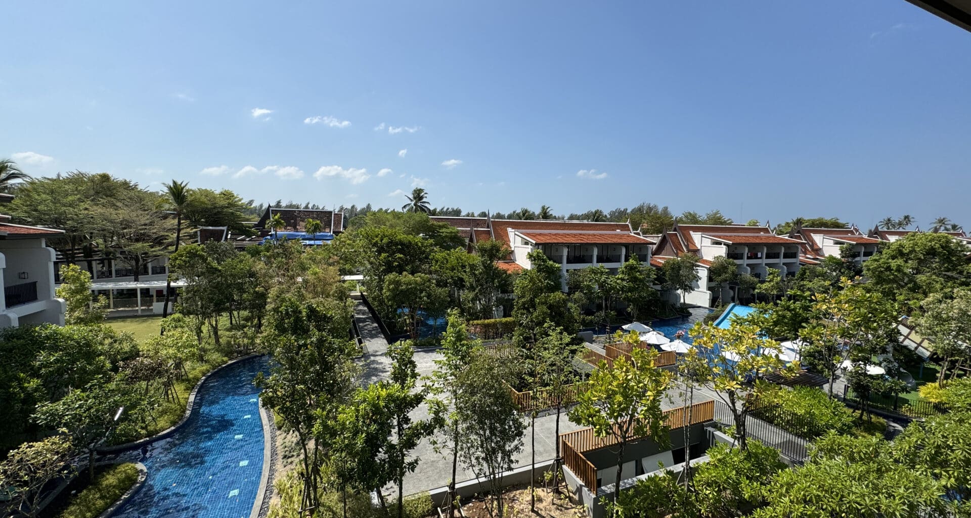 a pool with trees and buildings in the background