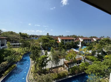 a pool with trees and buildings in the background