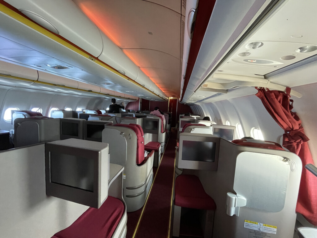 a plane with red seats and red curtains