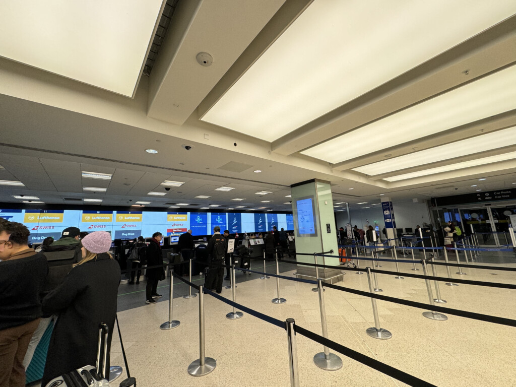 people standing in a line at an airport