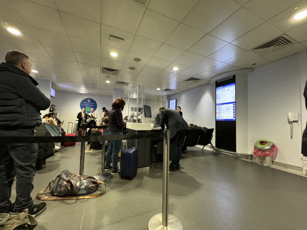 people standing in a line at a check in counter