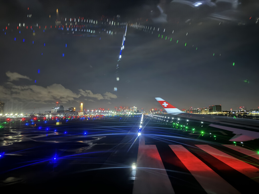 a plane wing on a runway at night