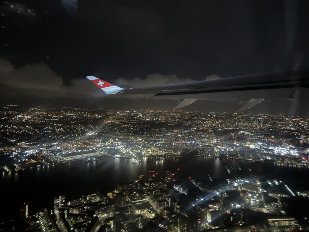 an airplane wing and city at night