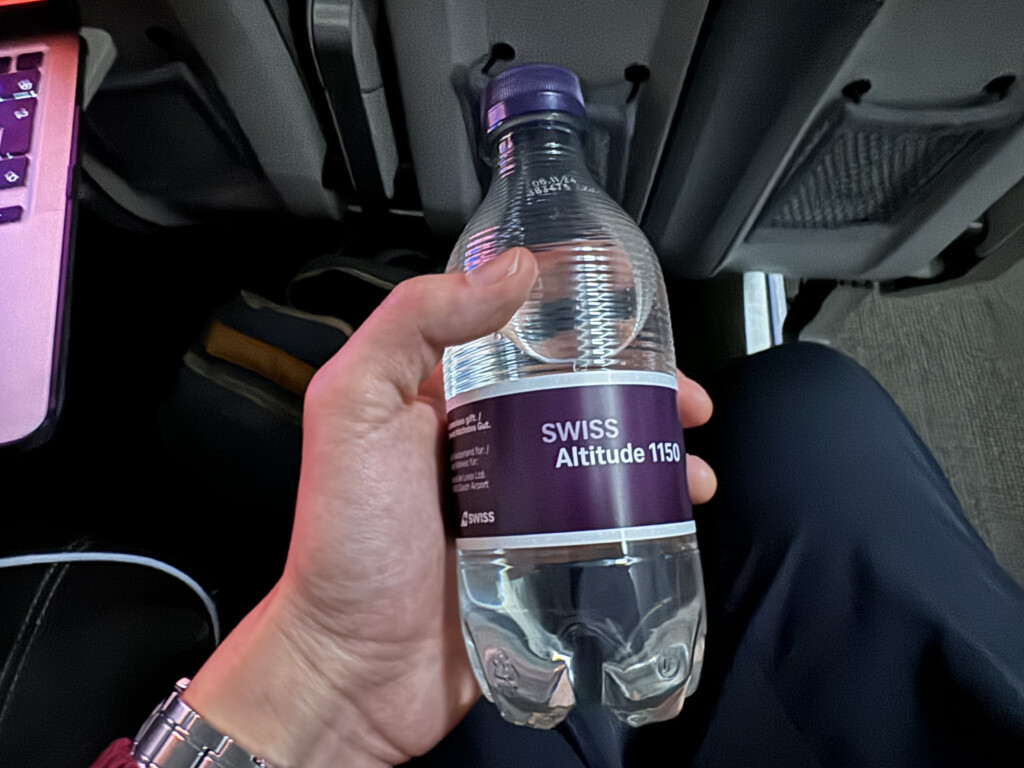 a hand holding a plastic bottle