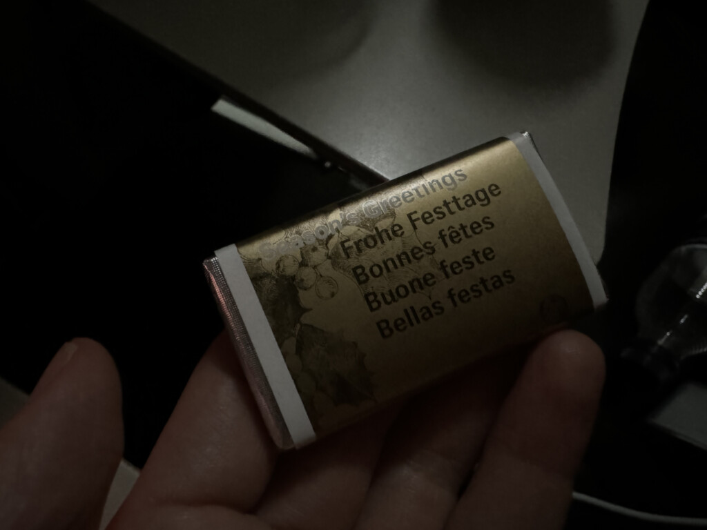 a hand holding a small package