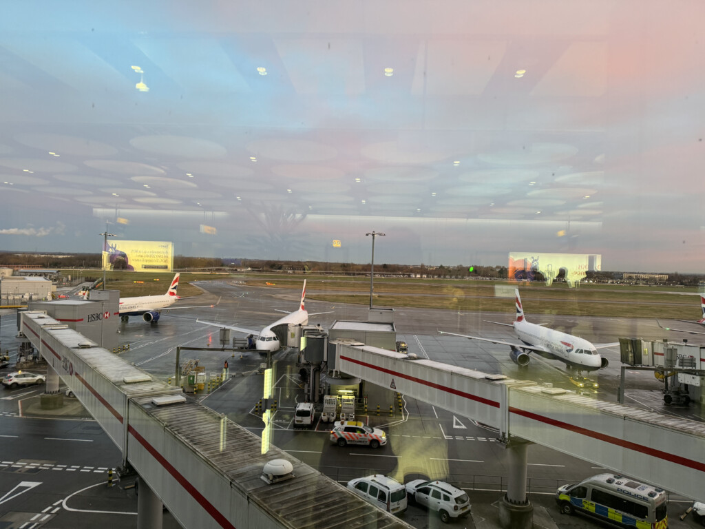 an airport with airplanes and cars