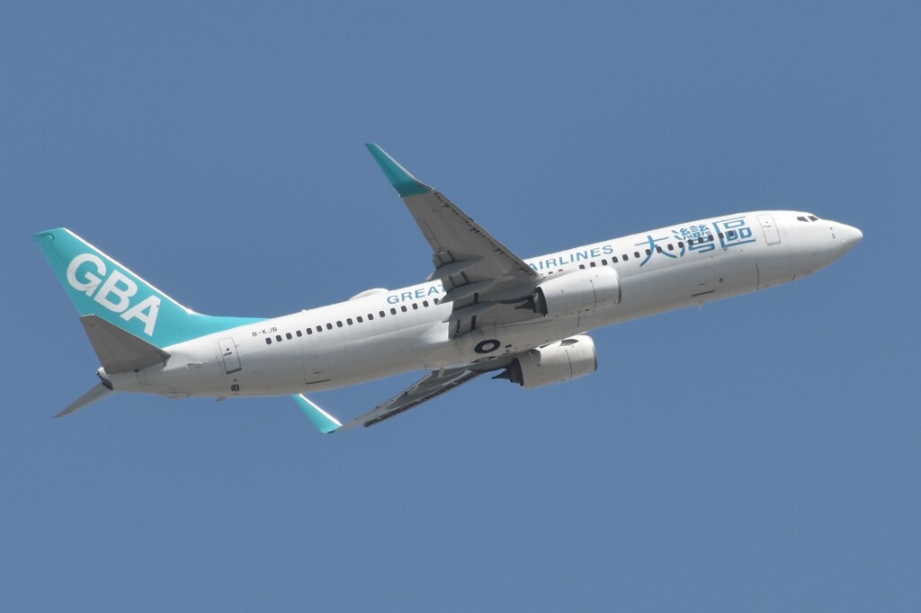 a white and blue airplane in the sky