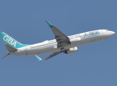 a white and blue airplane in the sky