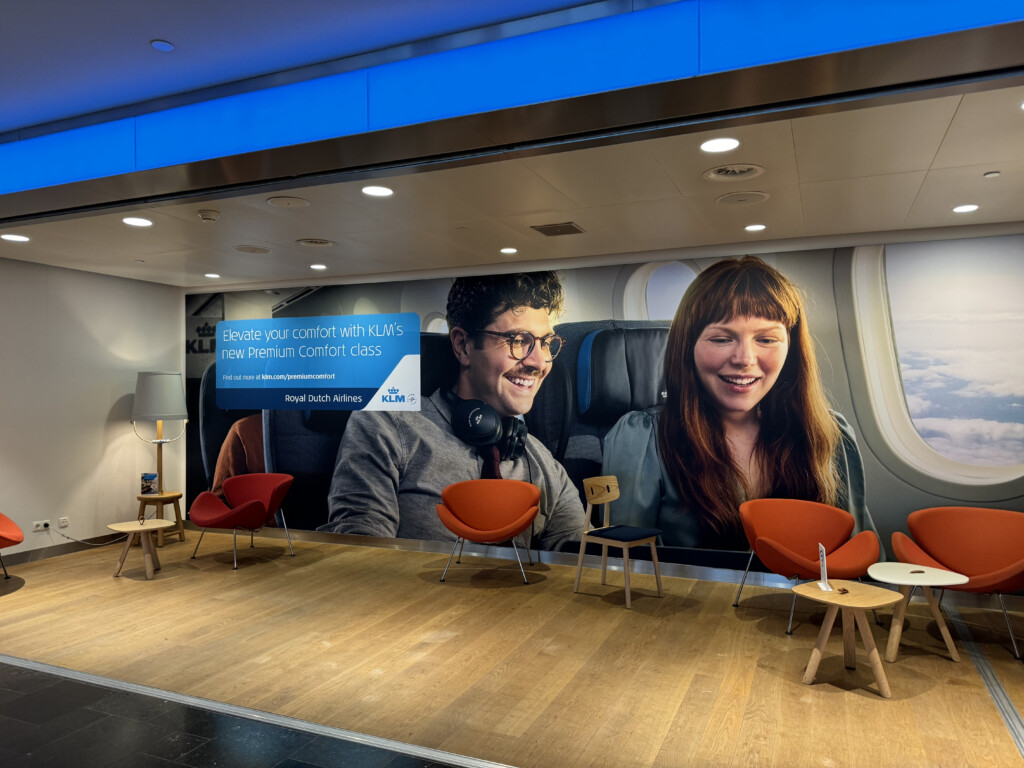 a large poster of a man and woman sitting in an airplane