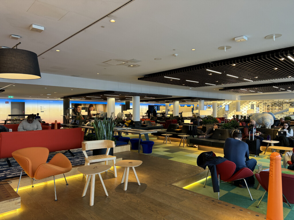 a room with people sitting in chairs and tables