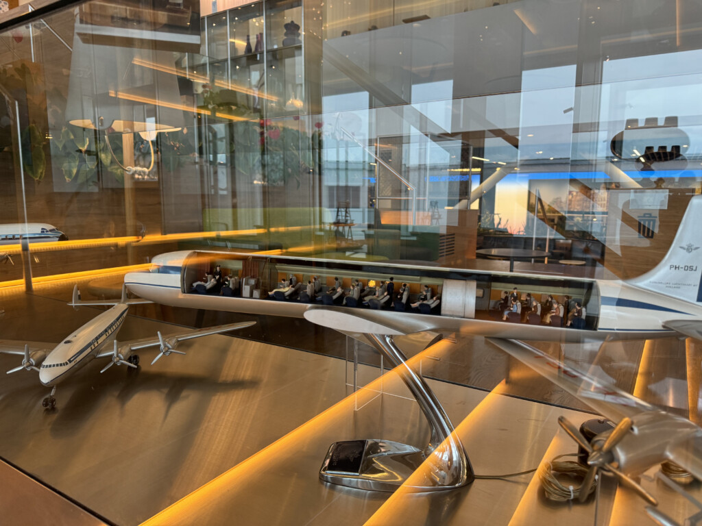 a glass wall with a table and a model airplane