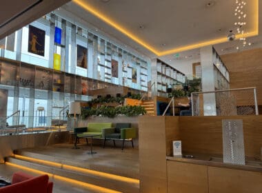 a room with a staircase and chairs