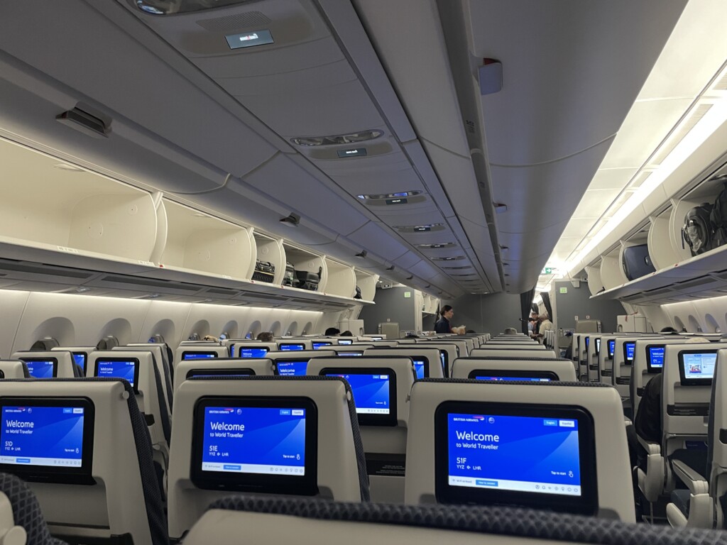 a row of seats with monitors on the back