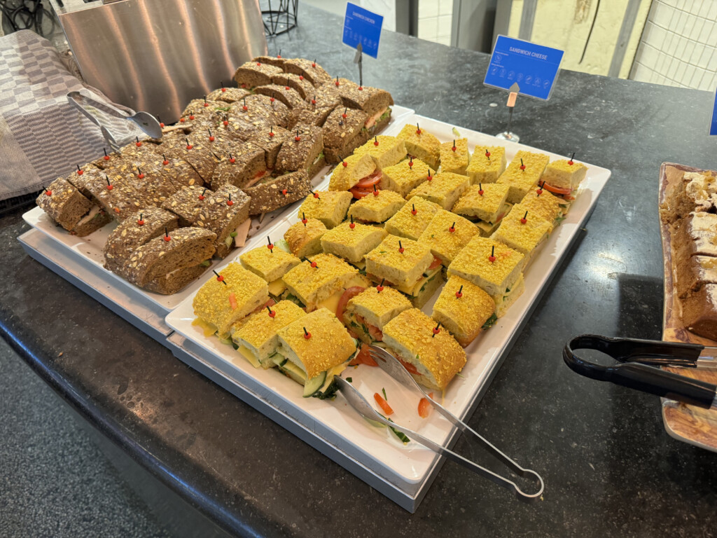 a trays of sandwiches on a counter