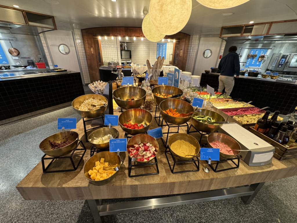 a buffet table with bowls of food