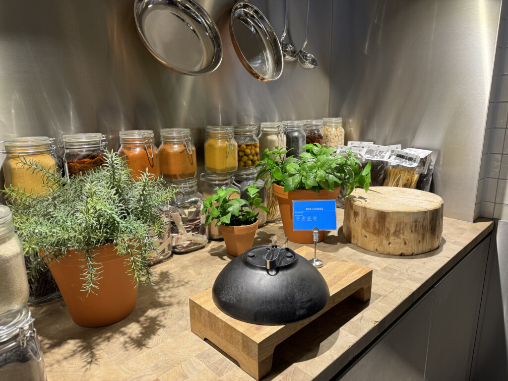 a kitchen counter with potted plants and pots of spices