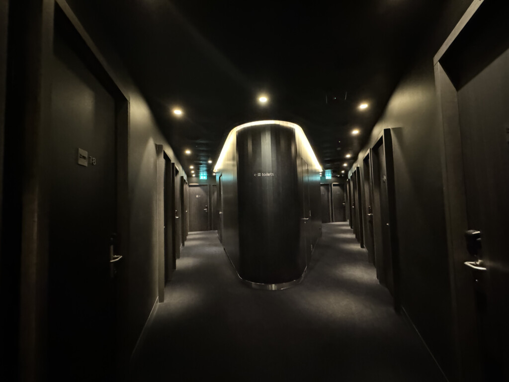 a hallway with doors and a cylinder