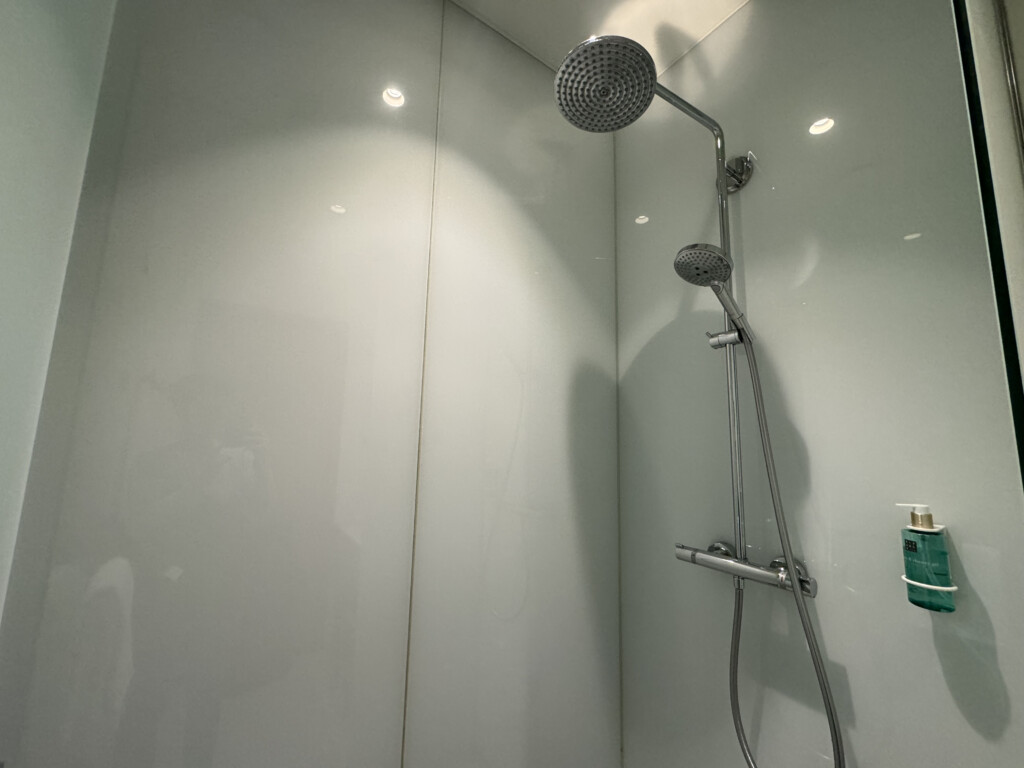 a shower head in a white bathroom