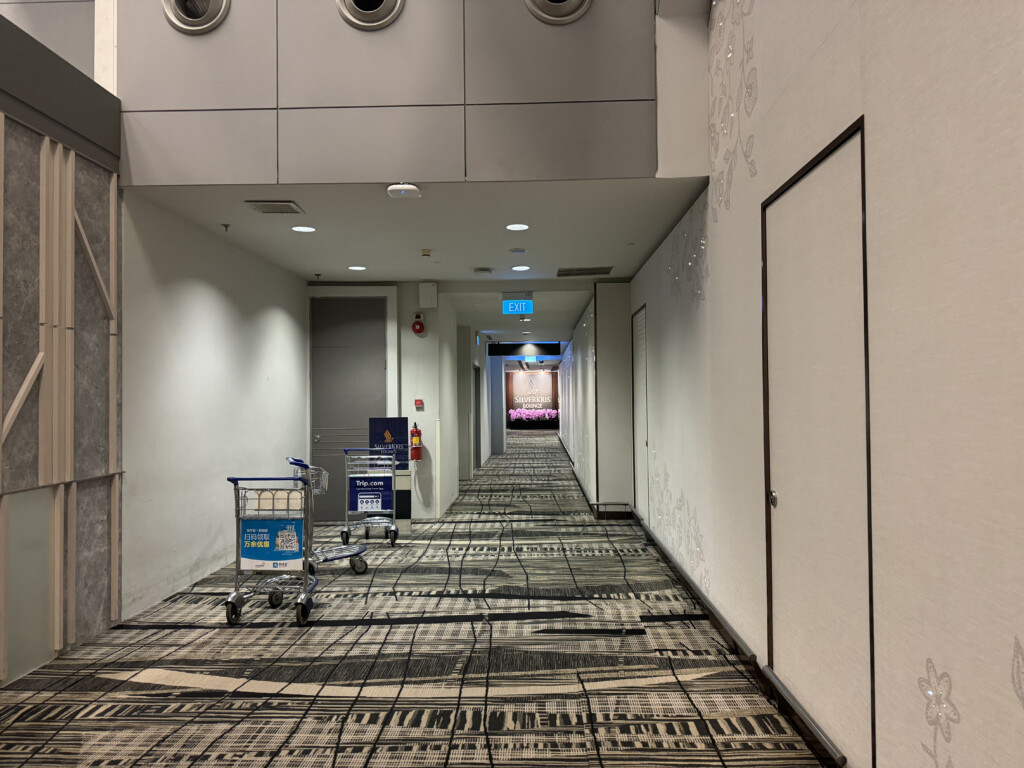 a hallway with a trolley and a door