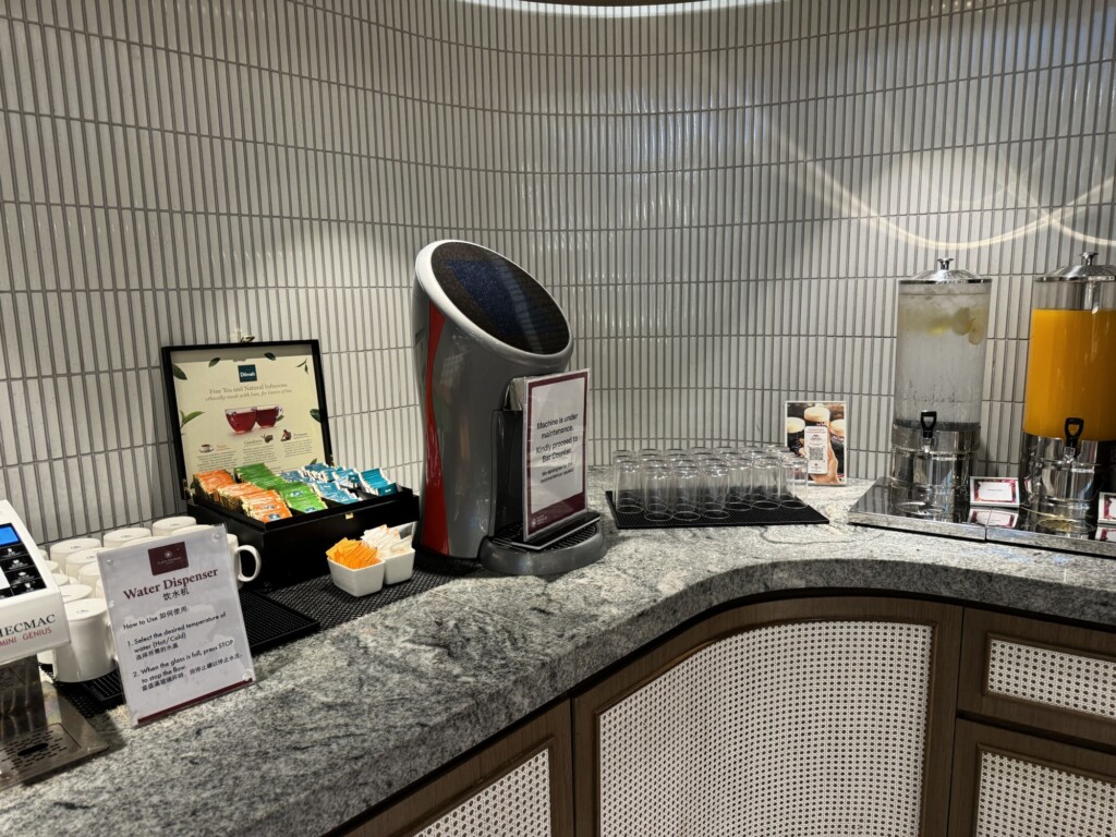 a counter with a coffee machine and cups