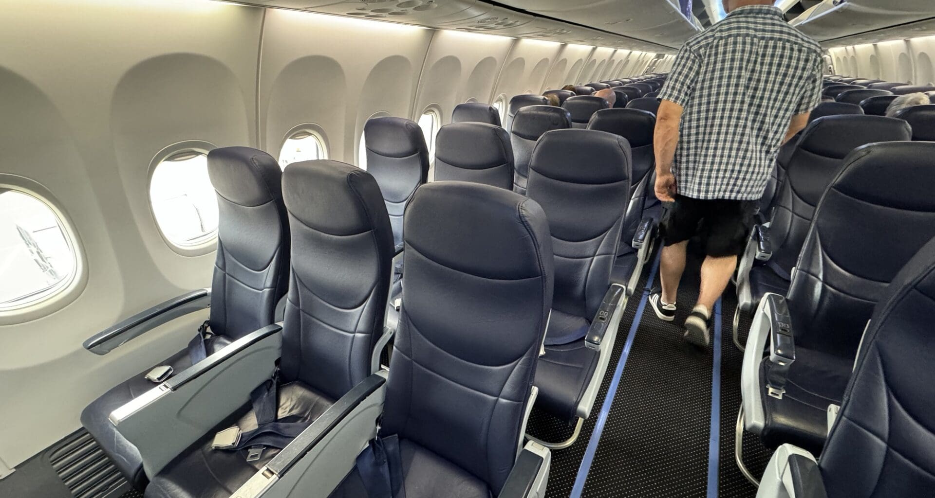 a man walking in an airplane