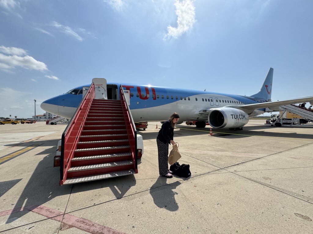 a woman standing next to a plane