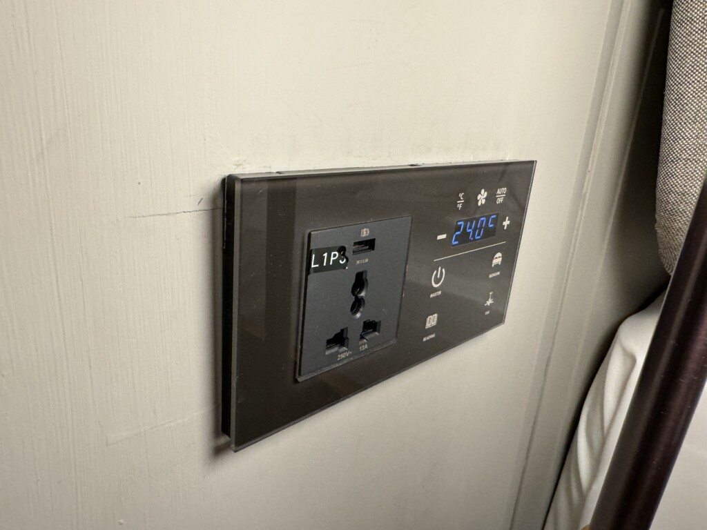 a black outlet with a digital display on a wall