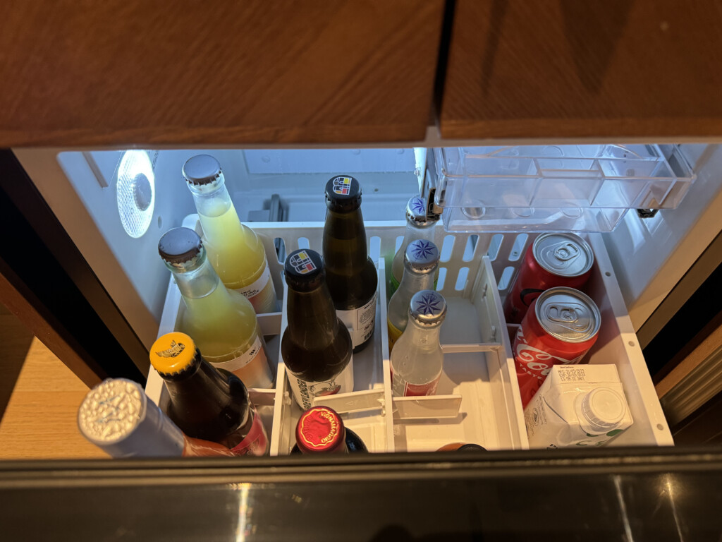 a refrigerator with bottles and cans