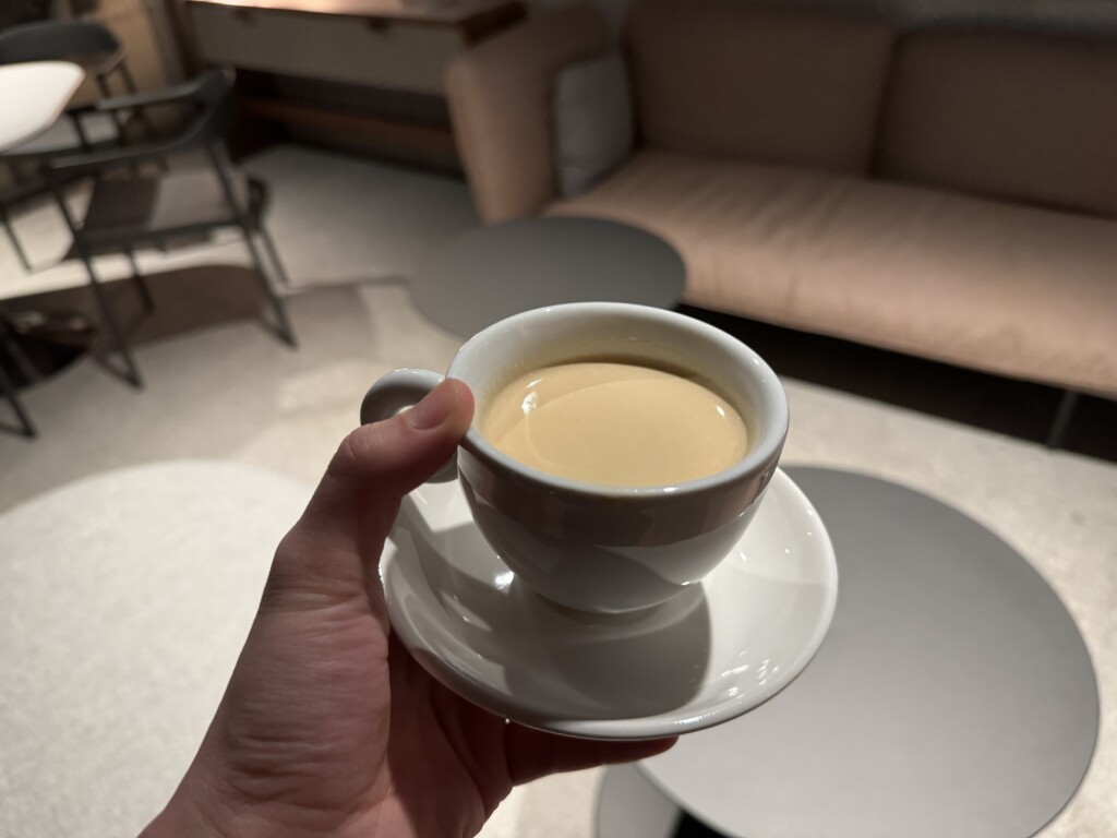 a hand holding a cup of coffee