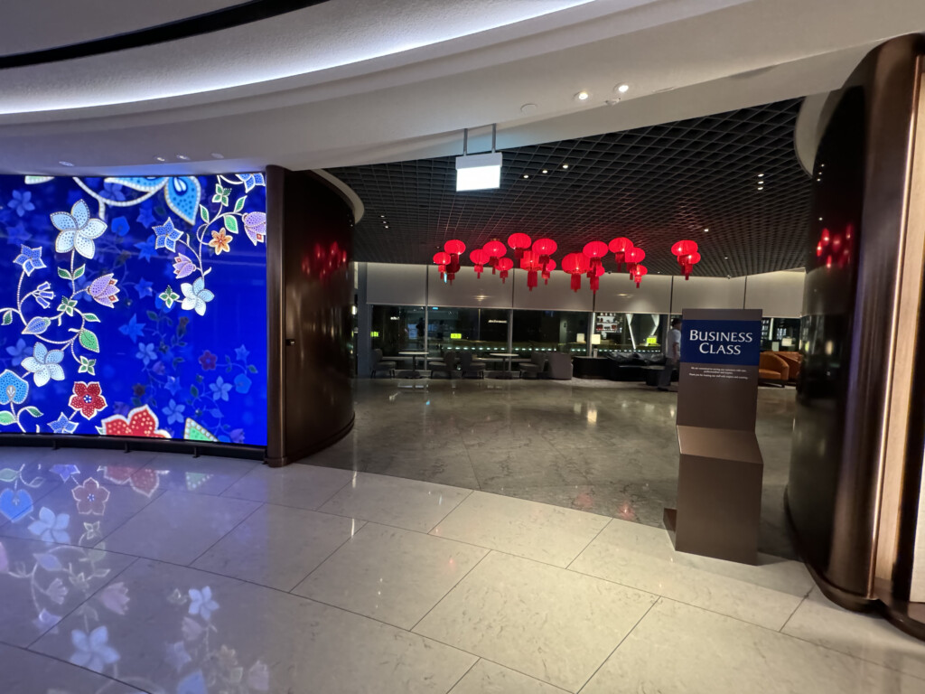 a lobby with red lanterns from the ceiling