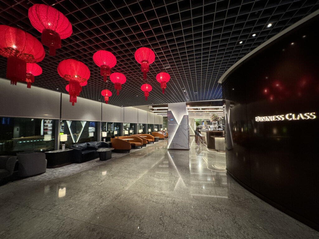 a lobby with red lanterns from the ceiling