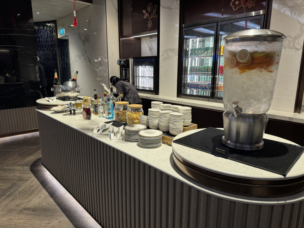 a counter with a drink dispenser and many plates