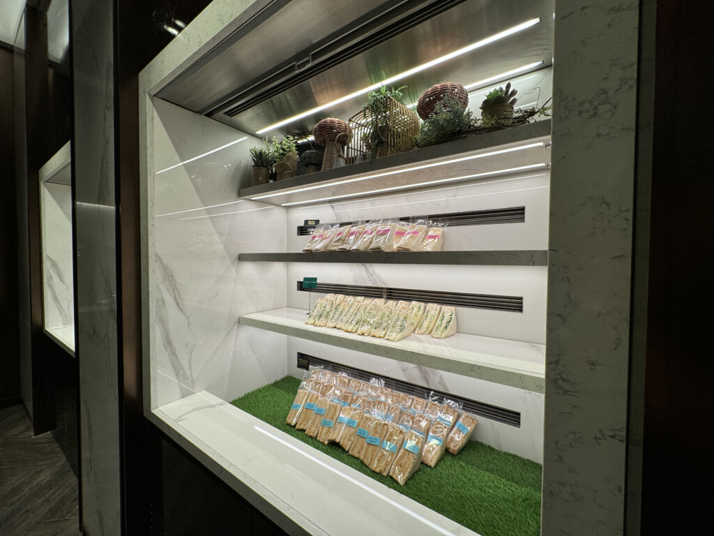 a display case with plants and bags