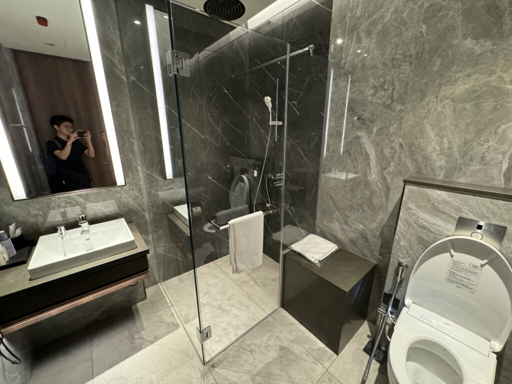 a bathroom with a glass shower and sink