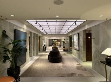 a hallway with chairs and a plant