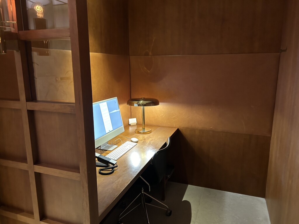 a desk with a computer and a lamp