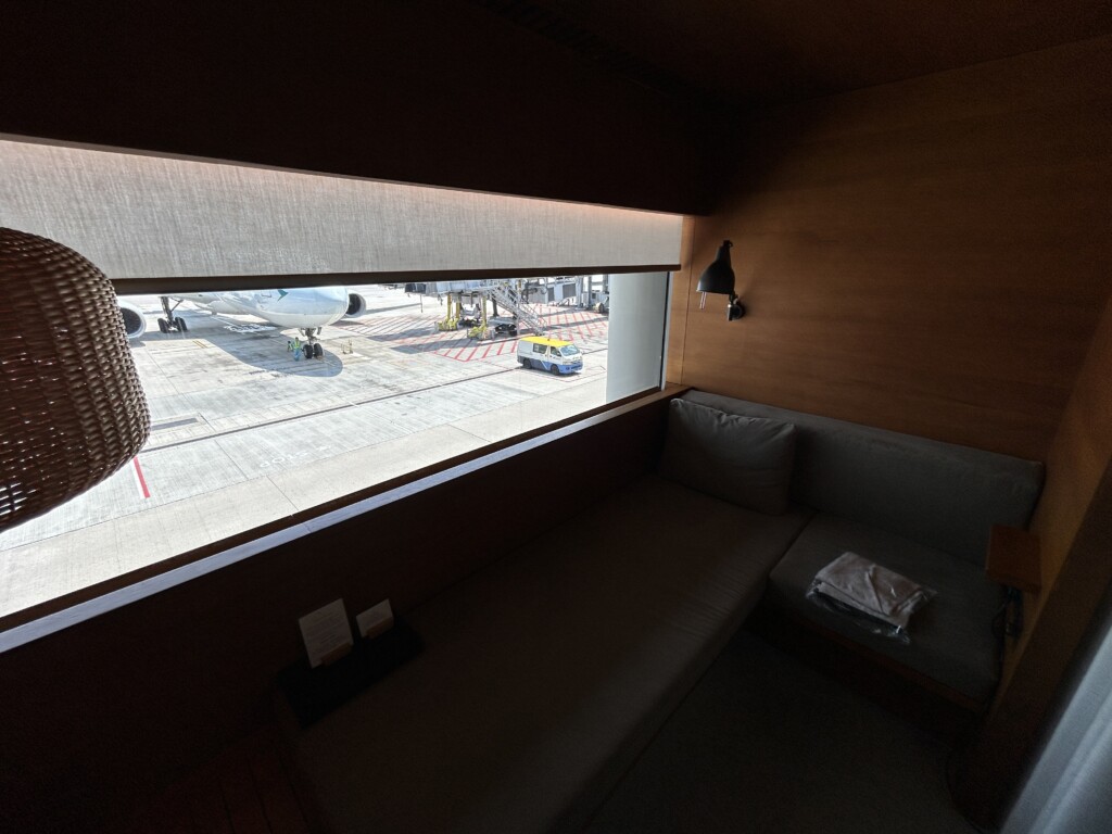 a window with a couch and a lamp