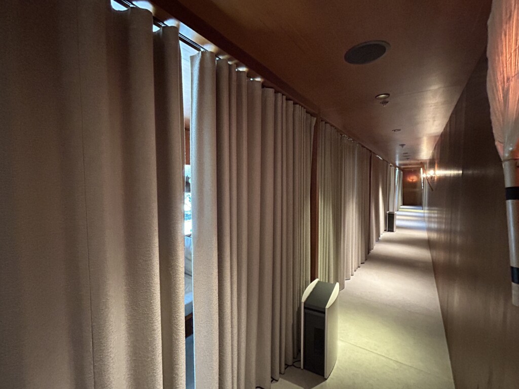 a long hallway with white curtains