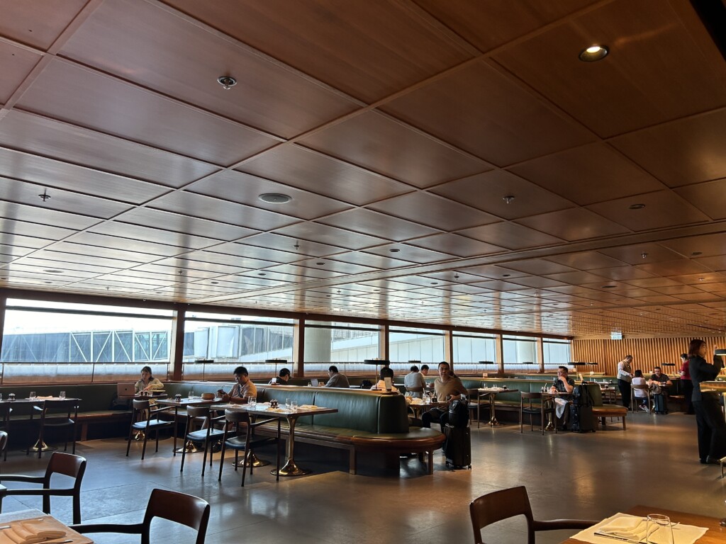 a group of people sitting at tables in a restaurant